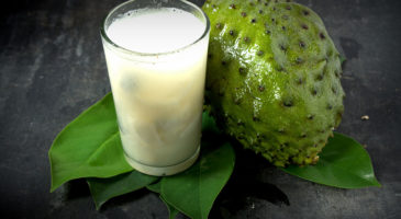 Soursop - Graviola juice in glass with Fresh soursop fruit